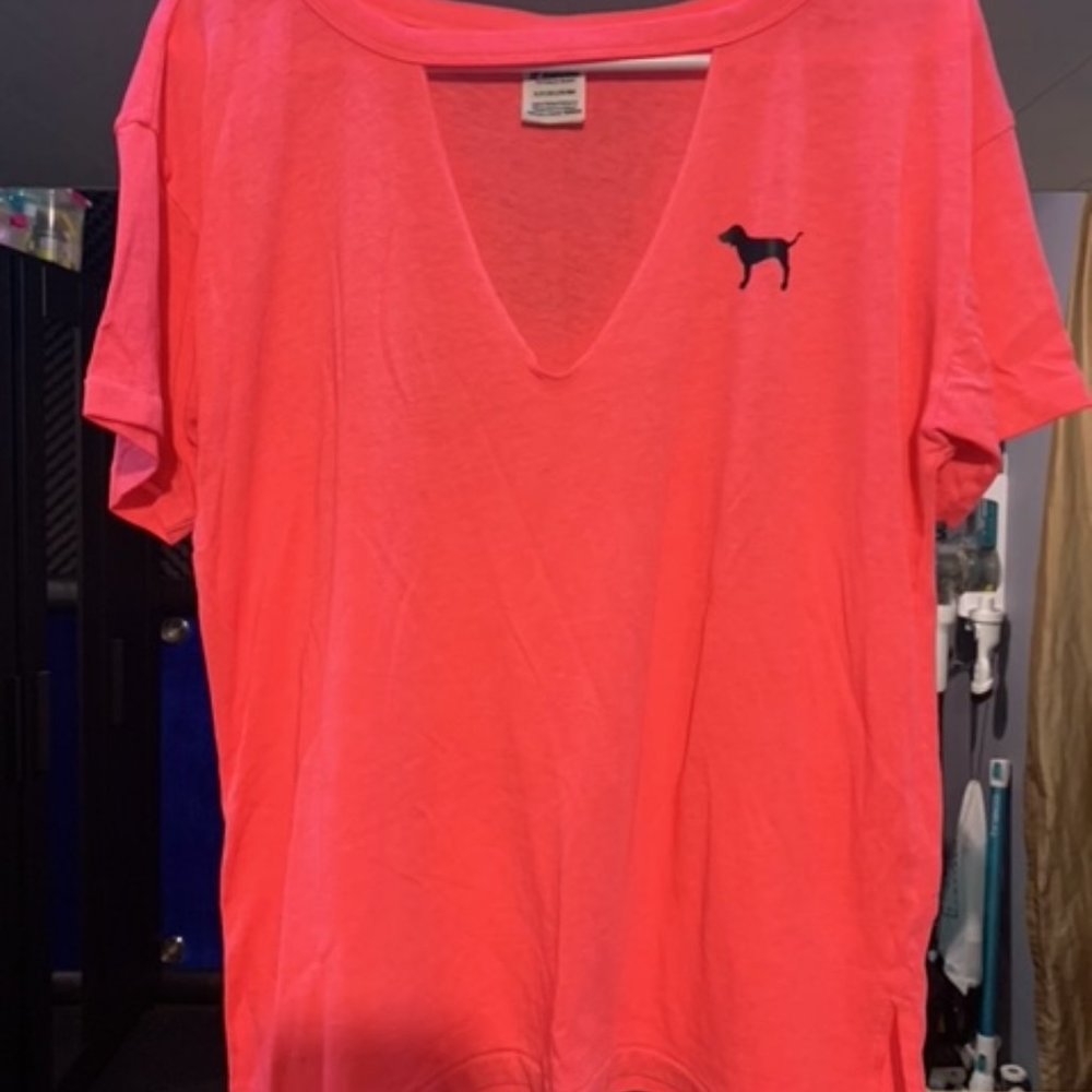 Victoria’s Secret pink T-shirt with an open chest.